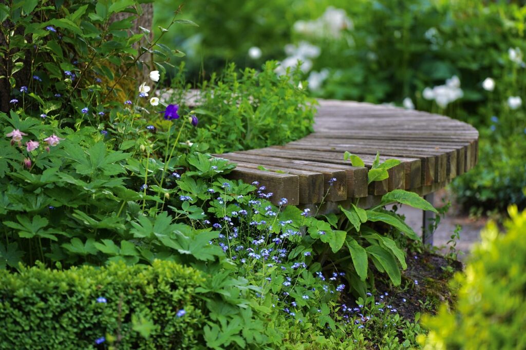 a curved garden seating area with lovely planting all around it